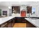 Modern kitchen with dark cabinets, white countertops, stainless steel appliances and a stylish backsplash at 2448 Broadway St, Indianapolis, IN 46205
