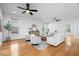 Spacious living room with hardwood floors, plush seating, ceiling fans and natural light at 2448 Broadway St, Indianapolis, IN 46205