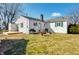 Backyard view with a deck, grill, and a mix of grass and trees on a sunny day at 249 Spring St, Plainfield, IN 46168