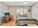 Cozy bedroom with a comfortable bed, a wood desk, and natural light from the window at 249 Spring St, Plainfield, IN 46168
