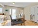 Light-filled dining area with a modern table, seating for six, and hardwood floors at 249 Spring St, Plainfield, IN 46168