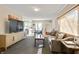 Open-concept living and dining area with a gray sofa, a TV, and hardwood floors at 249 Spring St, Plainfield, IN 46168