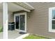 The covered back patio features a grill, sliding glass door and tan siding at 2626 Solidago Dr, Plainfield, IN 46168