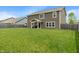 Large backyard features a spacious lawn and the home's tan siding at 2626 Solidago Dr, Plainfield, IN 46168