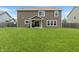 Spacious backyard with a large, well-maintained lawn, fence, and patio at 2626 Solidago Dr, Plainfield, IN 46168