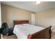 Neutral-walled bedroom with a wooden frame bed, neutral carpet and an abundance of light at 2626 Solidago Dr, Plainfield, IN 46168