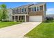 Two-story home with two-car garage, brick and siding exterior, manicured lawn and long driveway at 2626 Solidago Dr, Plainfield, IN 46168