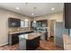 Well-lit kitchen features wooden cabinets, stainless steel appliances, and kitchen island with granite countertop at 2626 Solidago Dr, Plainfield, IN 46168