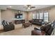 Cozy living room with a ceiling fan, mounted TV, modern furniture, and neutral color palette at 2626 Solidago Dr, Plainfield, IN 46168