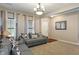 Comfortable living room featuring a plush grey sofa with stylish pillows, and a modern ceiling light at 2626 Solidago Dr, Plainfield, IN 46168