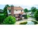 A two-story home featuring a wooden deck, a screened-in porch, brick chimney and a swimming pool in the backyard at 286 N Greenbriar Dr, Greenwood, IN 46142