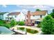 Backyard with an in-ground pool, wooden deck, and lush green trees, and a view of the two-story home at 286 N Greenbriar Dr, Greenwood, IN 46142