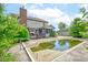 Backyard view of a two story home with a pool, deck, sunroom, and shed under a sunny sky at 286 N Greenbriar Dr, Greenwood, IN 46142