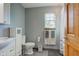 Bathroom features a white vanity, toilet, linen cabinet, towels, and gray walls at 286 N Greenbriar Dr, Greenwood, IN 46142