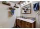 Well-lit bathroom with a wooden vanity, granite countertop, and decorative shelving at 286 N Greenbriar Dr, Greenwood, IN 46142