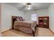Comfortable bedroom with neutral carpet, ceiling fan and wooden armoire, perfect for relaxation at 286 N Greenbriar Dr, Greenwood, IN 46142