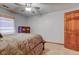 This comfy bedroom features neutral carpet, a ceiling fan, and a wooden door at 286 N Greenbriar Dr, Greenwood, IN 46142