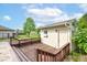 Deck with dark wooden railings, leading to a shed and backyard, under a sunny sky at 286 N Greenbriar Dr, Greenwood, IN 46142