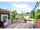 Deck with hot tub and pool, leading to a sunroom, shed, and backyard at 286 N Greenbriar Dr, Greenwood, IN 46142