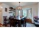 Inviting dining room featuring a stylish light fixture, a bay window, and a dark wood table at 286 N Greenbriar Dr, Greenwood, IN 46142