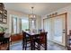 Inviting dining area featuring a stylish light fixture, large bay window, and ample seating at 286 N Greenbriar Dr, Greenwood, IN 46142
