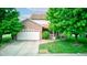 Charming brick home with a well-maintained lawn, two-car garage and inviting front porch at 286 N Greenbriar Dr, Greenwood, IN 46142