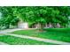 Well-manicured lawn leads up to a lovely home with a two-car garage, and inviting front porch at 286 N Greenbriar Dr, Greenwood, IN 46142