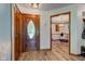 Bright foyer with wood-look floors, an elegant front door, and views into the dining area at 286 N Greenbriar Dr, Greenwood, IN 46142
