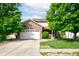 Charming home featuring a brick facade, two-car garage, and well-maintained lawn with mature trees at 286 N Greenbriar Dr, Greenwood, IN 46142