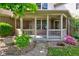 Inviting front porch with brick accents, flower arrangements, and a cozy seating area at 286 N Greenbriar Dr, Greenwood, IN 46142