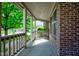 Covered front porch featuring a brick wall and a rocking chair, perfect for relaxing outdoors at 286 N Greenbriar Dr, Greenwood, IN 46142