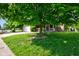 Well-manicured front yard with lush green grass and mature trees shading a brick home at 286 N Greenbriar Dr, Greenwood, IN 46142