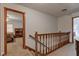 Upstairs hallway with wooden banister, and carpet flooring at 286 N Greenbriar Dr, Greenwood, IN 46142