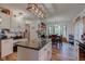Open kitchen and dining area with an island, stylish lighting, and great natural light from bay windows at 286 N Greenbriar Dr, Greenwood, IN 46142