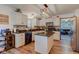 Bright kitchen with granite countertops, white cabinetry, a center island, and wood-look flooring at 286 N Greenbriar Dr, Greenwood, IN 46142