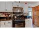 Updated kitchen features granite countertops, stainless appliances, and mosaic backsplash at 286 N Greenbriar Dr, Greenwood, IN 46142