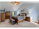 Spacious main bedroom boasts blue walls, high ceiling, wooden furniture, and TV at 286 N Greenbriar Dr, Greenwood, IN 46142