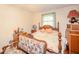 Bedroom with wood furniture, including a bed, nightstand, dresser, and two windows at 2900 Helms Rd, Anderson, IN 46016