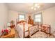 Bedroom with wood furniture, including a bed, nightstand, dresser, and two windows at 2900 Helms Rd, Anderson, IN 46016