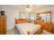 Bedroom with wood furniture, including a bed, nightstand, dresser, and two windows at 2900 Helms Rd, Anderson, IN 46016