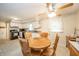 Bright dining area featuring a round wooden table, white cabinets, and a ceiling fan at 2900 Helms Rd, Anderson, IN 46016