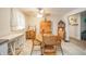 Cozy dining area with wooden table and chairs, bright lighting, and classic decor elements at 2900 Helms Rd, Anderson, IN 46016