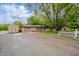 Inviting ranch-style home with a spacious yard, gravel driveway, and an attached garage at 2900 Helms Rd, Anderson, IN 46016