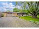 Charming ranch-style home with a well-maintained lawn, gravel driveway, and welcoming front porch at 2900 Helms Rd, Anderson, IN 46016