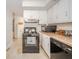 Traditional kitchen with white cabinets, black appliances, and a double basin sink under a window at 2900 Helms Rd, Anderson, IN 46016