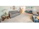 Open-concept living area with comfortable seating, traditional decor, and neutral carpeting at 2900 Helms Rd, Anderson, IN 46016