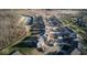 Aerial view of a new residential development with single-Gathering homes and a water feature at 331 Oxford Ln, Lebanon, IN 46052