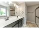 Modern bathroom with double sinks, sleek countertops, and walk-in shower at 331 Oxford Ln, Lebanon, IN 46052