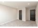 Neutral bedroom featuring gray carpet, light gray walls, and two black doors at 331 Oxford Ln, Lebanon, IN 46052