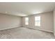 Large bedroom with neutral carpet and ample natural light from two big windows at 331 Oxford Ln, Lebanon, IN 46052